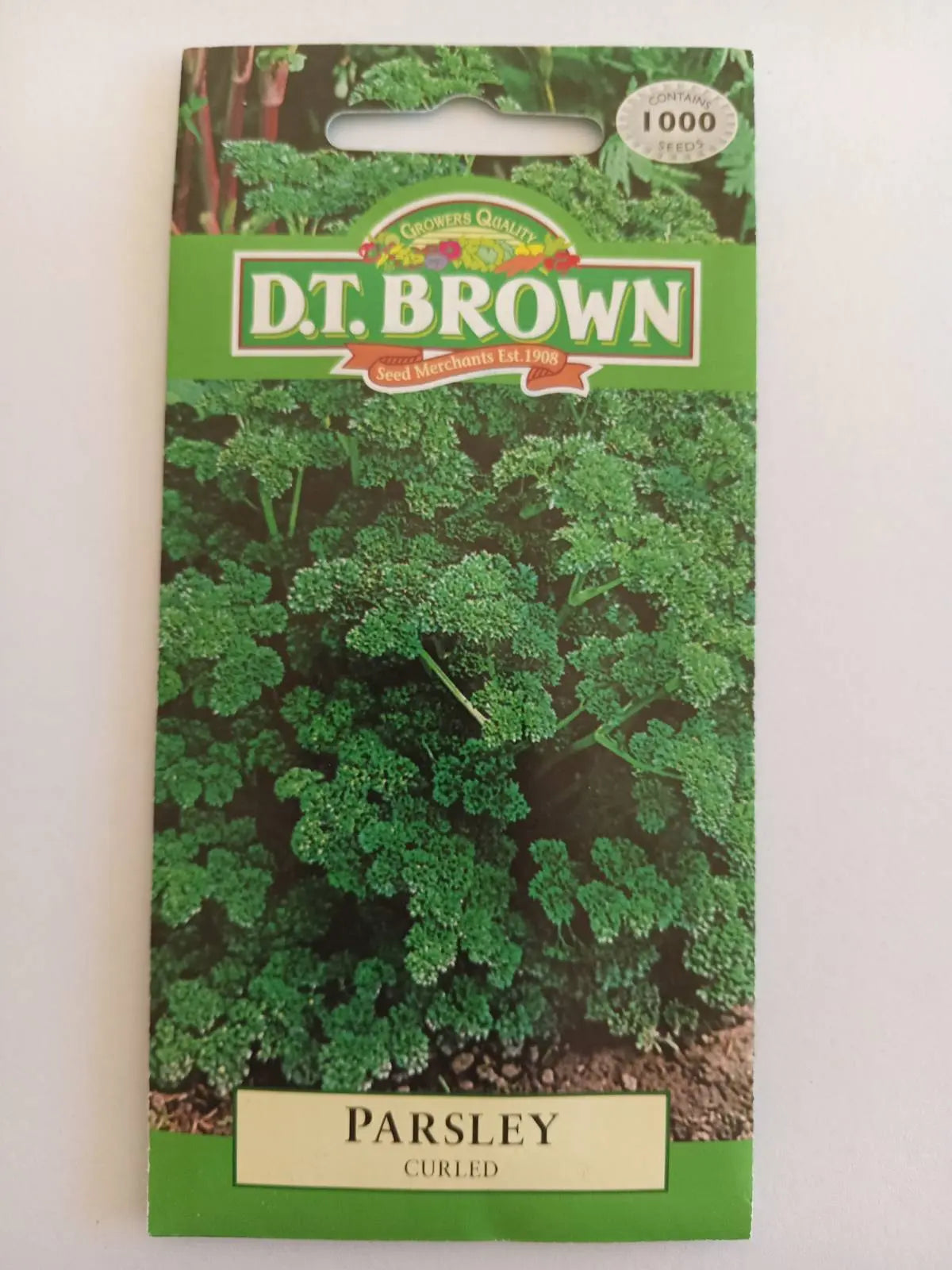 Seed packet for curly parsley with D.T. Brown branding on a white background